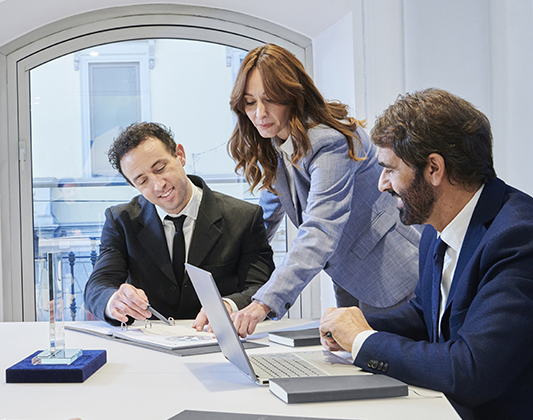 Bankers speak while looking at a document