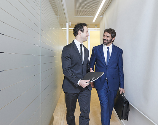 Banker and customer in the corridors of the main office in Milan
